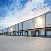 Exterior of modern distribution center warehouse at sunrise